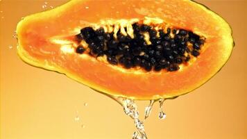 Fresh tropical papaya with drops and splashes of water. Filmed on a high-speed camera at 1000 fps. High quality FullHD footage video