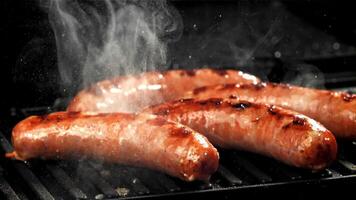 Sausages are fried with splashes in a pan. Filmed on a high-speed camera at 1000 fps. High quality FullHD footage video