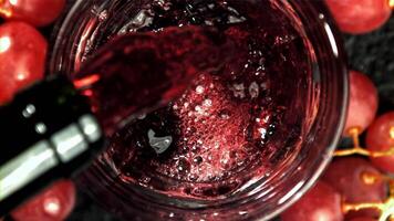 Red wine is poured into a glass. Top view. Filmed on a high-speed camera at 1000 fps. High quality FullHD footage video