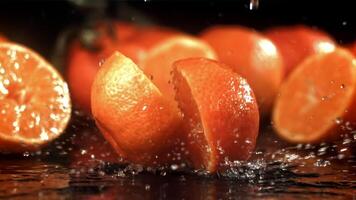 A tangerine breaks into two halves when it falls. Filmed on a high-speed camera at 1000 fps. High quality FullHD footage video