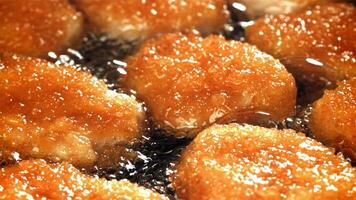 Chicken nuggets are fried in oil. Filmed on a high-speed camera at 1000 fps. High quality FullHD footage video