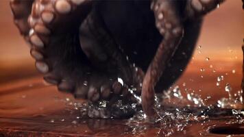 A fresh octopus falls on a cutting board. Filmed on a high-speed camera at 1000 fps. High quality FullHD footage video