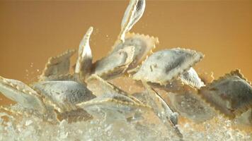 Italian ravioli fly up and fall down with flour. Filmed on a high-speed camera at 1000 fps. High quality FullHD footage video