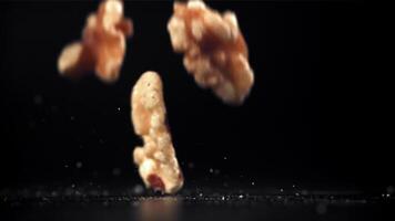 Walnuts fall on the table. Filmed on a high-speed camera at 1000 fps. High quality FullHD footage video