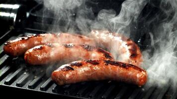 Sausages are fried with splashes in a pan. Filmed on a high-speed camera at 1000 fps. High quality FullHD footage video