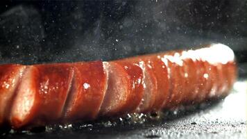 Sausages are fried with splashes in a pan. Filmed on a high-speed camera at 1000 fps. High quality FullHD footage video