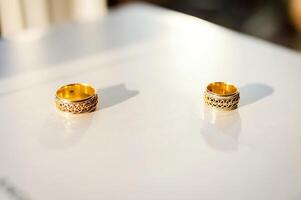 Wedding golden metal rings. Pair of jewelery gold rings. Marriage celebration. photo