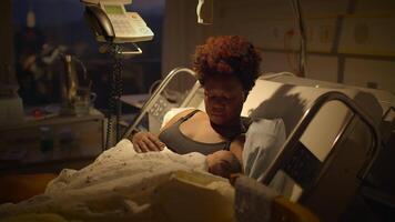 Young African Mother Lying in Hospital Bed Holding Newborn Baby After Birth video
