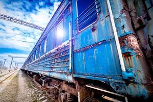 old rusty weathered peeled paint of an old wagon. photo