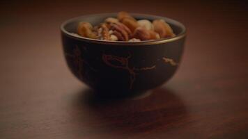 Mixed Nuts of Almonds Pecan Walnuts Cashews Hazelnuts on Wooden Table video