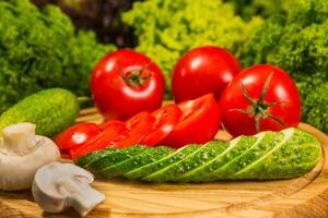 Fresh vegetables on a wooden board. Delicious vegetarian food. Vegetables are perfectly laid out on a wooden background. photo