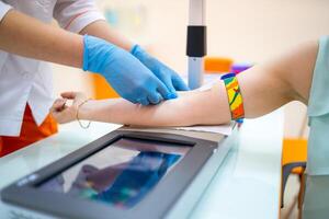 Nurse taking a blood sample, close up photo