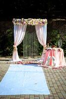 Decorated table for wedding cake with grey tablecloth and candles photo