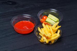 Junk food. Fast food. French fries, sauce on the table. photo