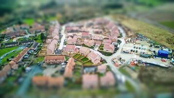 Aerial view of a suburban neighborhood with tilt-shift effect, creating a miniature scene appearance. photo