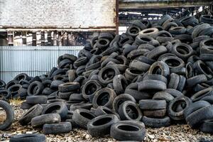 Old rubber tires dumped. View of mound of used car tires in a junkyard photo