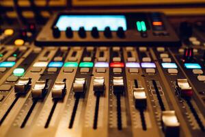 professional studio mixing console with faders for DJ work. Close-up photo