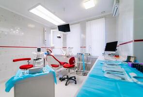 Dentistry, oral, medical equipment and stomatology concept - interior of new modern dental clinic office with chair. Raw of stomatology instruments. photo