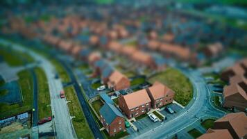 Aerial view of a suburban neighborhood with tilt-shift effect, creating a miniature scene. photo