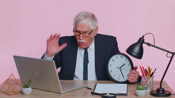 Senior businessman with anxiety checking time on clock, running late to work being in delay deadline video