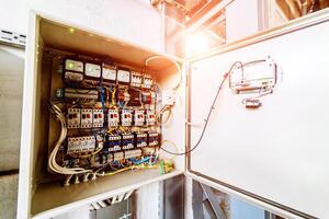 Electrical panel at a assembly line factory. Controls and switches. photo