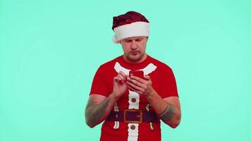 Man in red Christmas t-shirt use mobile phone typing browsing loses surprised sudden lottery results video