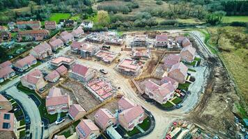 Aerial view of a residential housing development under construction with partially built homes and infrastructure. photo