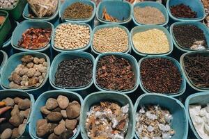 A closeup view of many types of herbs, placed on tray with square and rectangle shape. Traditional Indonesian medicine concept photo