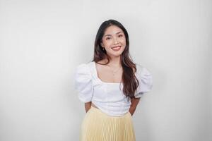 An attractive Asian woman is smiling to the camera, isolated by white background. photo