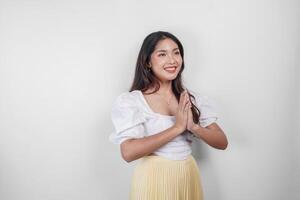 Friendly Asian woman is giving gestures of traditional greetings by her hands photo