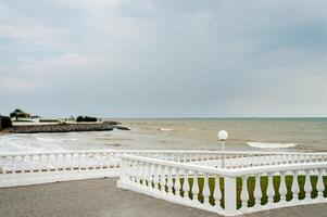 Panorama of the promenade with a parapet on a Sunny day by the sea. photo