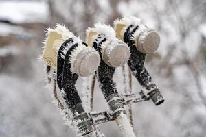 Satellite dish converter device in witer. Parabolic satellite antenna dish LNB converter detail covered by hoarfrost. Close-up. photo