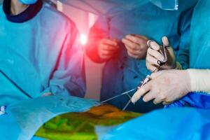 Spinal surgery. Group of surgeons in operating room with surgery equipment. Laminectomy. Modern medical background photo