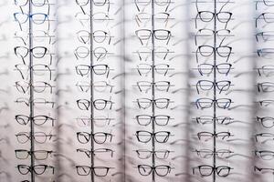 Row of luxury eyeglass at an opticians store. Gglasses background photo