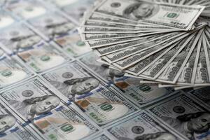 A Stack of Cash on a Table. A pile of money sitting on top of a table photo