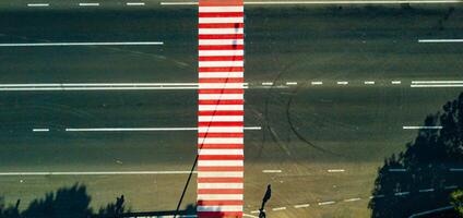 road with a pedestrian crossing of white and red color from the height. Close-up photo