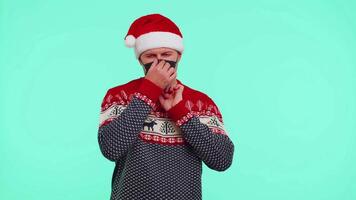 Man in Christmas red sweater wearing face mask ppe to safe from coronavirus on lockdown quarantine video