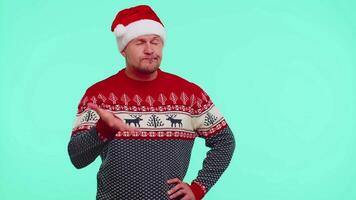 Upset man in Christmas red sweater making face palm gesture, feeling bored, disappointed, bad result video