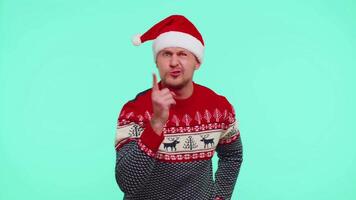 Displeased man in Christmas sweater gesturing hands with displeasure, blaming scolding for failure video