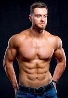 bodybuilder posing. Beautiful sporty guy male power. Fitness muscled man photo