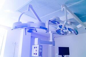 equipment and medical devices in modern operating room take with art lighting and blue filter photo