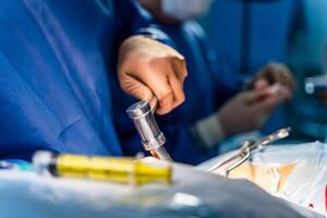 Operating room with surgery in progress. Medical team performing surgical operation in bright modern operating room photo