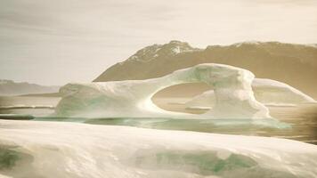 A large iceberg floating on top of a body of water video