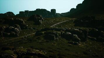 A view of some rocks and grass on a hill video