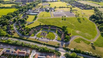 Aerial view of a lush green suburban area with residential houses, roads, and open spaces. photo