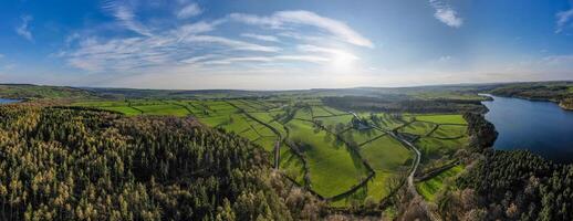 an aerial view of a green valley and river photo