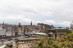 panorámico ver de Edimburgo paisaje urbano con histórico arquitectura y nublado cielo. foto