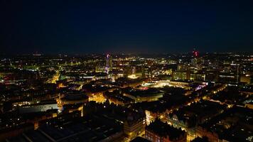 Aerial night view of a cityscape with illuminated buildings and streets, showcasing urban nightlife and architecture in Leeds. photo