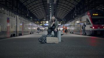 Elderly Homeless Man Suffering from Poverty Looking for Help at Train Station video