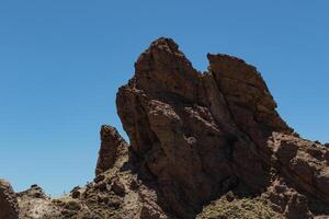 Majestic rock formations against a clear blue sky in the Teide, National Park, Tenerife photo